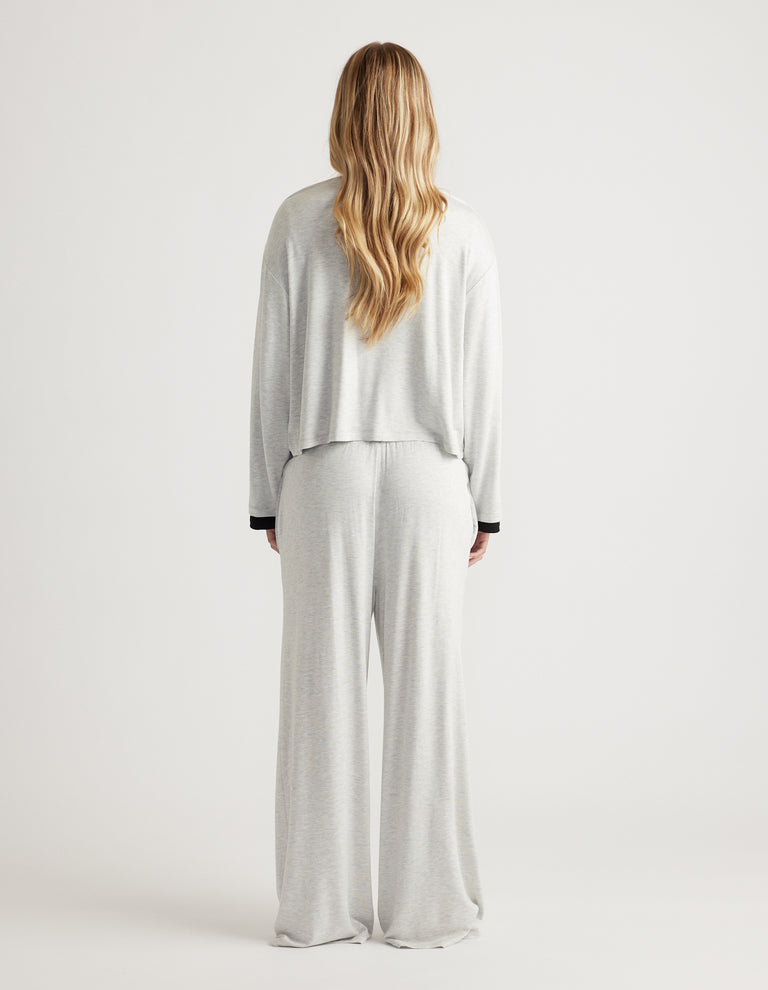 Back view of relaxed fit light grey sleep jersey long sleeve top and matching wide-leg pants in soft fabric