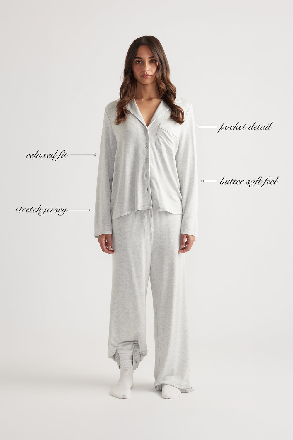 Woman wearing light grey sleep button through shirt with relaxed fit and matching wide leg pants in soft stretch jersey