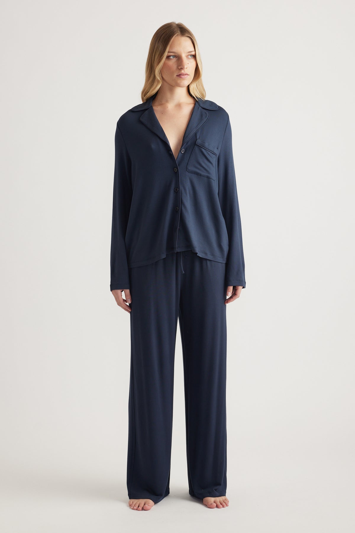 Woman wearing a navy button-through shirt with matching wide-leg pants