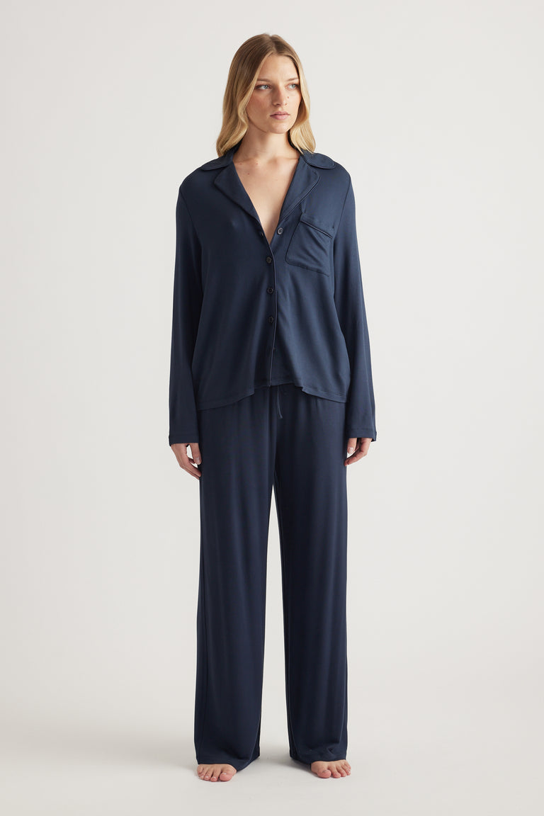 Woman wearing a navy button-through shirt with matching wide-leg pants