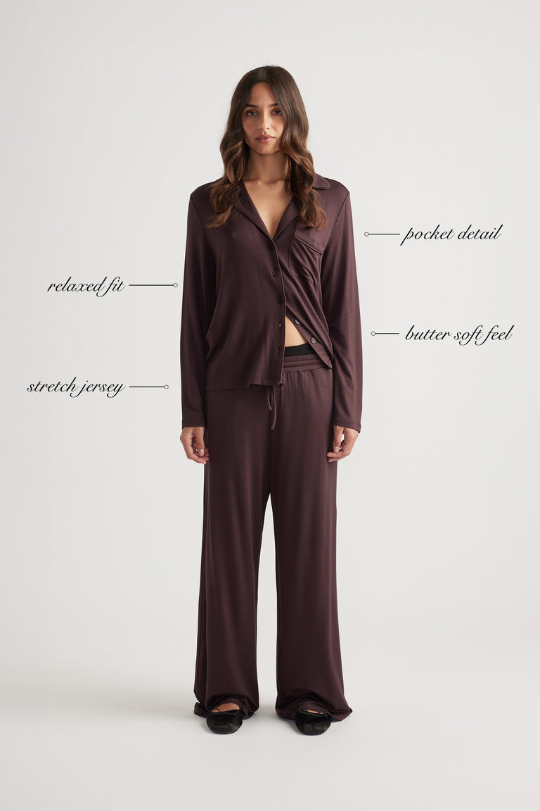 Woman wearing a relaxed fit sleep button through shirt in deep rhubarb with pocket detail and soft stretch jersey fabric