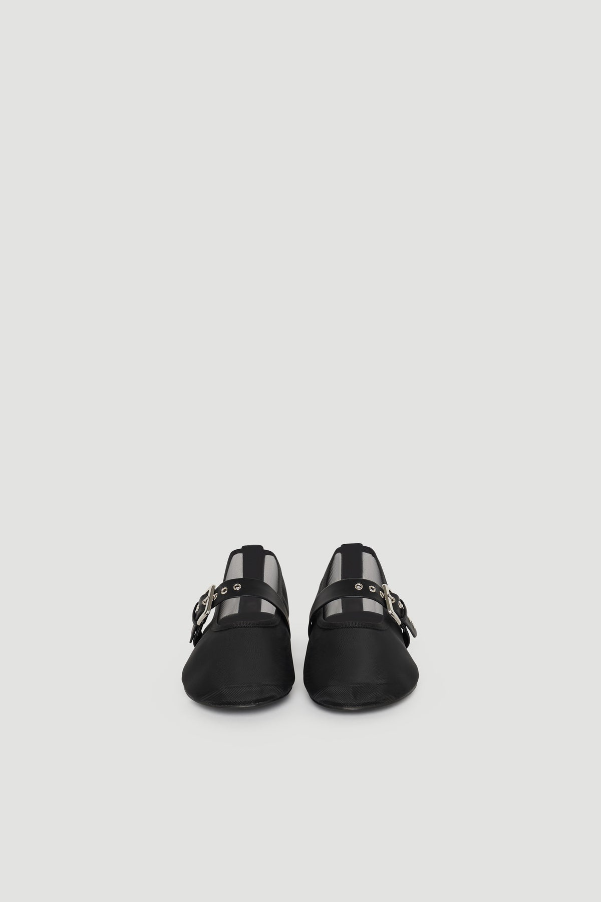 Pair of black ballet flats featuring mesh panels and buckle strap detailing for a stylish, modern look