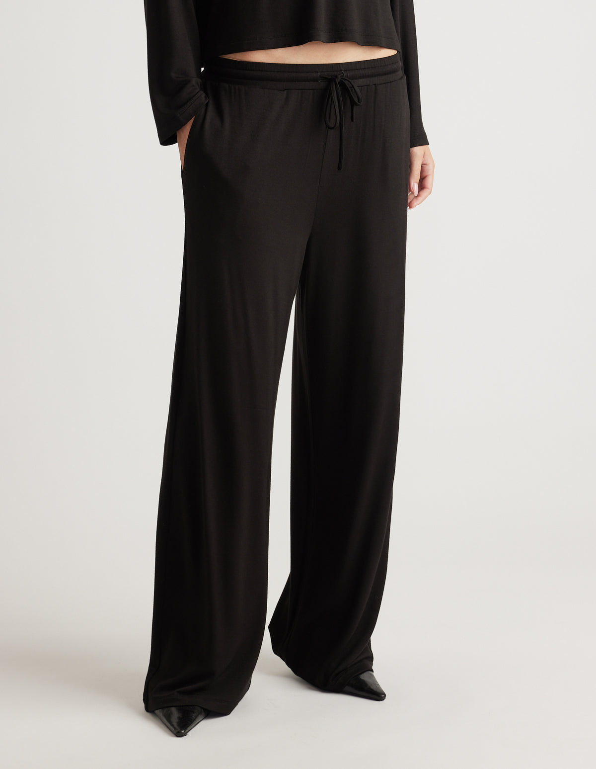 Black wide-leg pants in soft jersey fabric featuring a drawstring waist and relaxed fit for everyday comfort