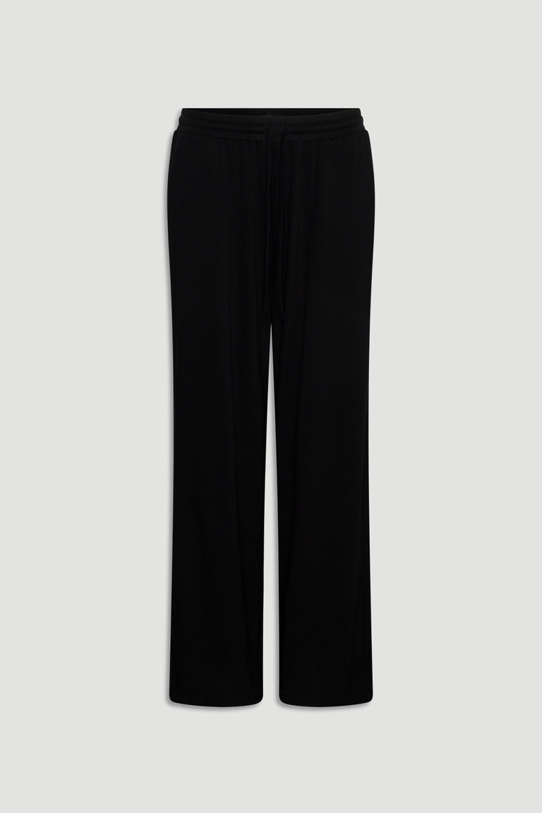 Black wide-leg lounge pants made from soft jersey fabric with an elastic waistband and drawstring detail