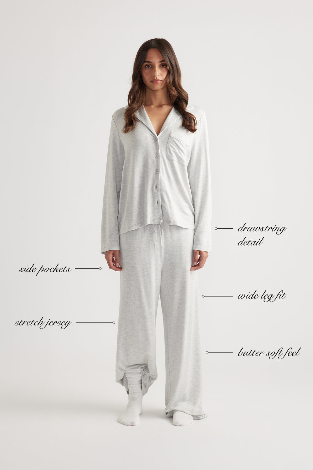 Woman wearing light grey wide leg sleep jersey pants with matching buttoned long sleeve top and relaxed fit