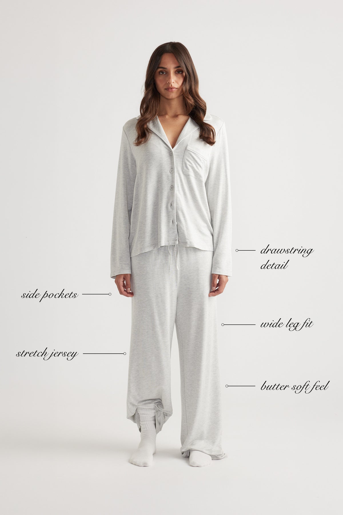 Woman wearing light grey wide leg sleep jersey pants with matching buttoned long sleeve top and relaxed fit