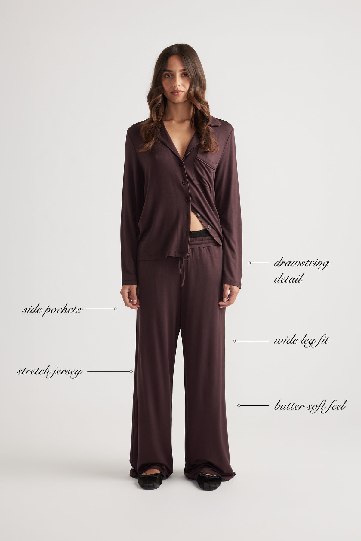 Woman wearing deep burgundy wide leg lounge pants and matching button-up top in soft stretch jersey fabric