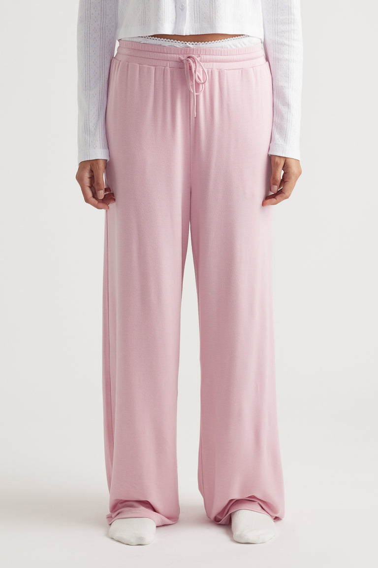 Light pink wide leg pants in soft sleep jersey fabric with elastic waistband and drawstring for relaxed, breathable comfort
