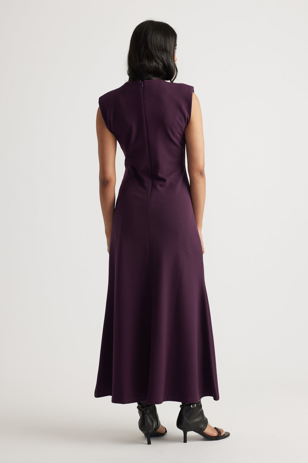 Back view of model wearing deep purple Bonnie Shoulder Pad Maxi Dress with structured shoulders by Decjuba Australian brand