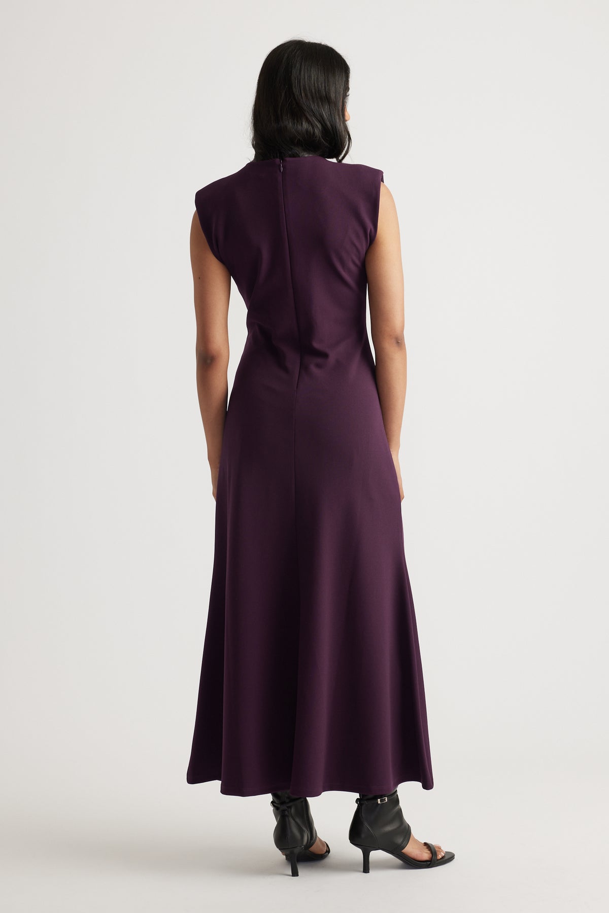 Back view of model wearing deep purple Bonnie Shoulder Pad Maxi Dress with structured shoulders by Decjuba Australian brand