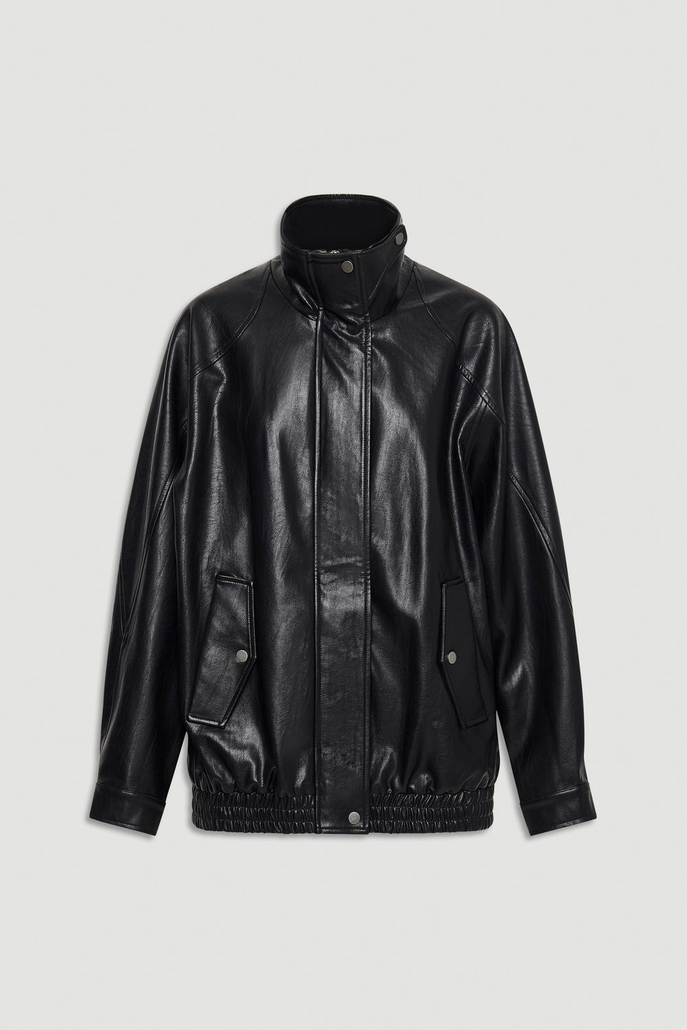 Black oversized jacket with high collar, snap button front, and elasticated hem for a relaxed fit.
