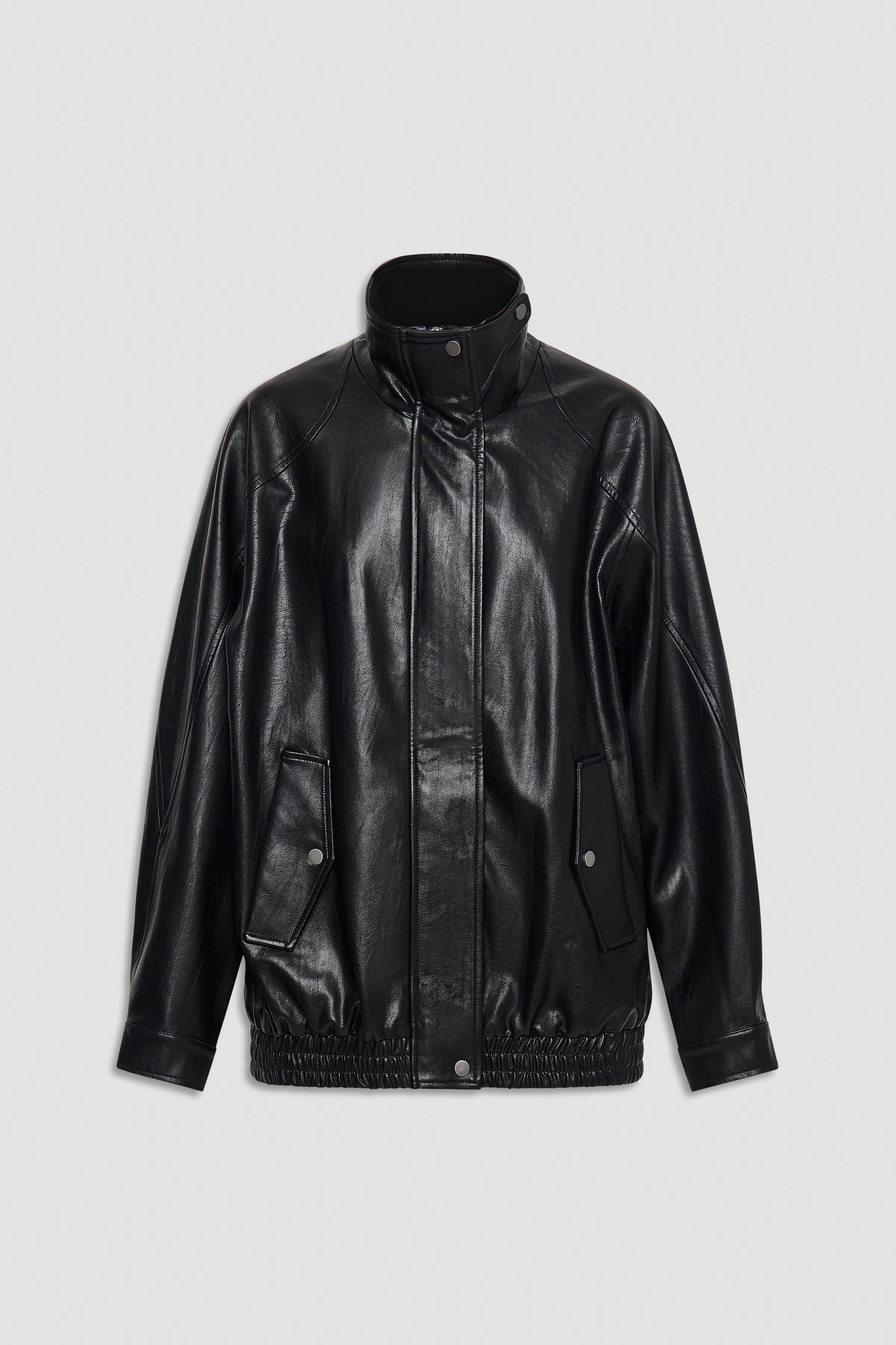Black oversized jacket with high collar, snap button front, and elasticated hem for a relaxed fit.