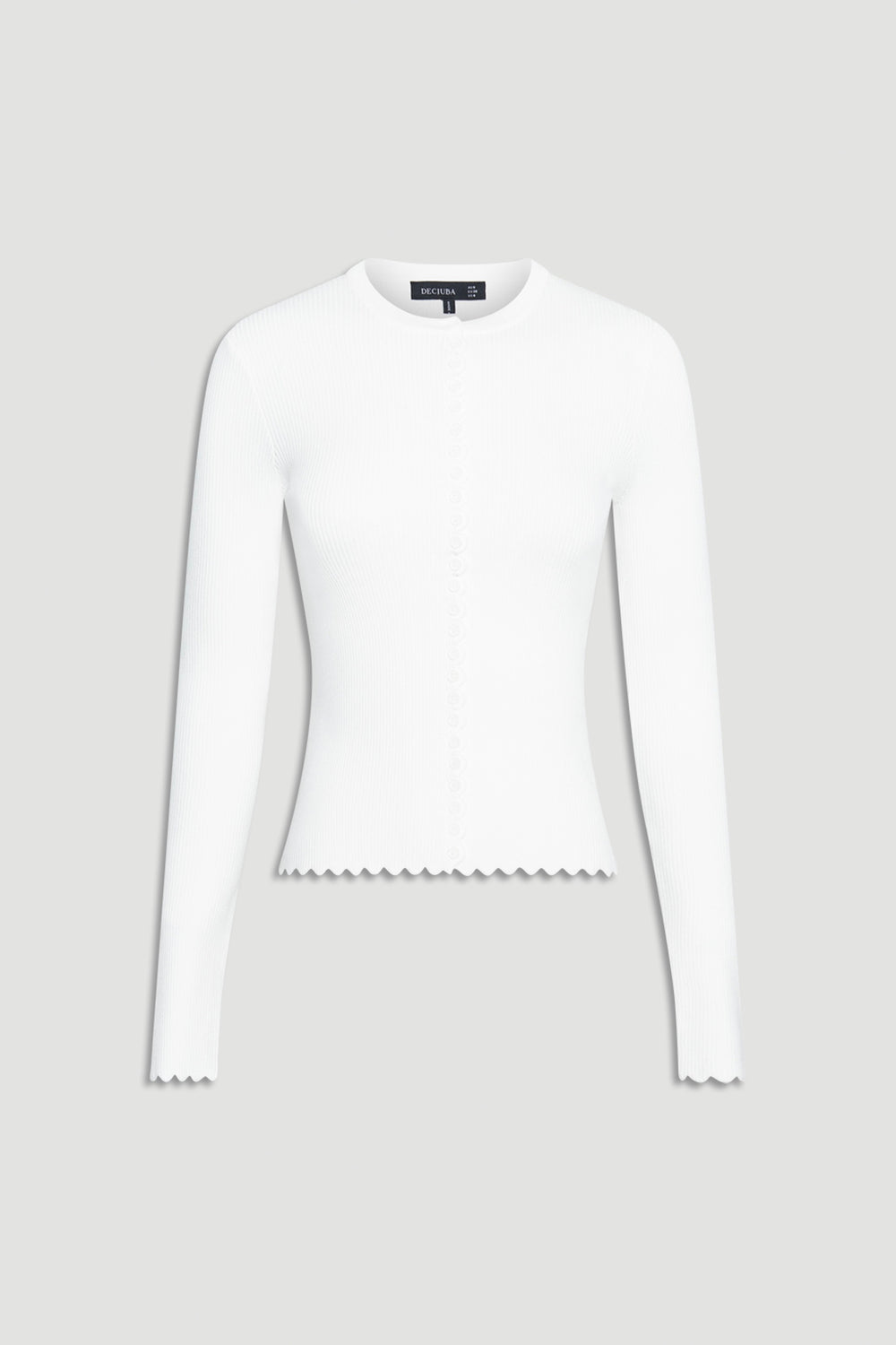 White fitted long-sleeve top featuring subtle scalloped edges on cuffs and hem with delicate button detailing down the front