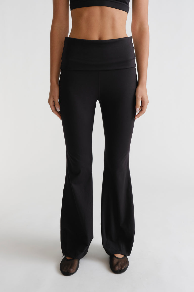 Front view of woman wearing black D-Luxe Flare Legging with a high waistband and fitted flare silhouette by DECJUBA