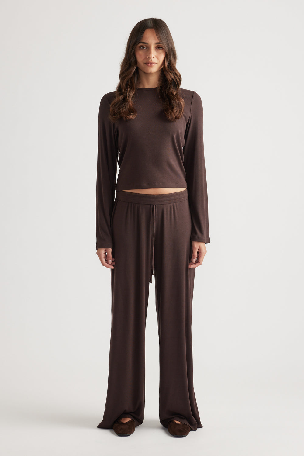 Front view of soft chocolate brown long sleeve ribbed top paired with wide-leg relaxed pants for cozy loungewear style