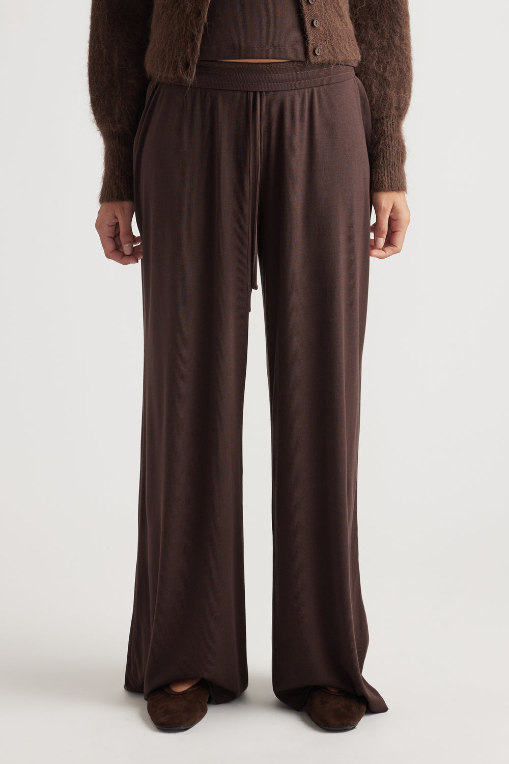 Soft ribbed wide-leg lounge pants in deep chocolate hue with relaxed fit and elastic waistband detail