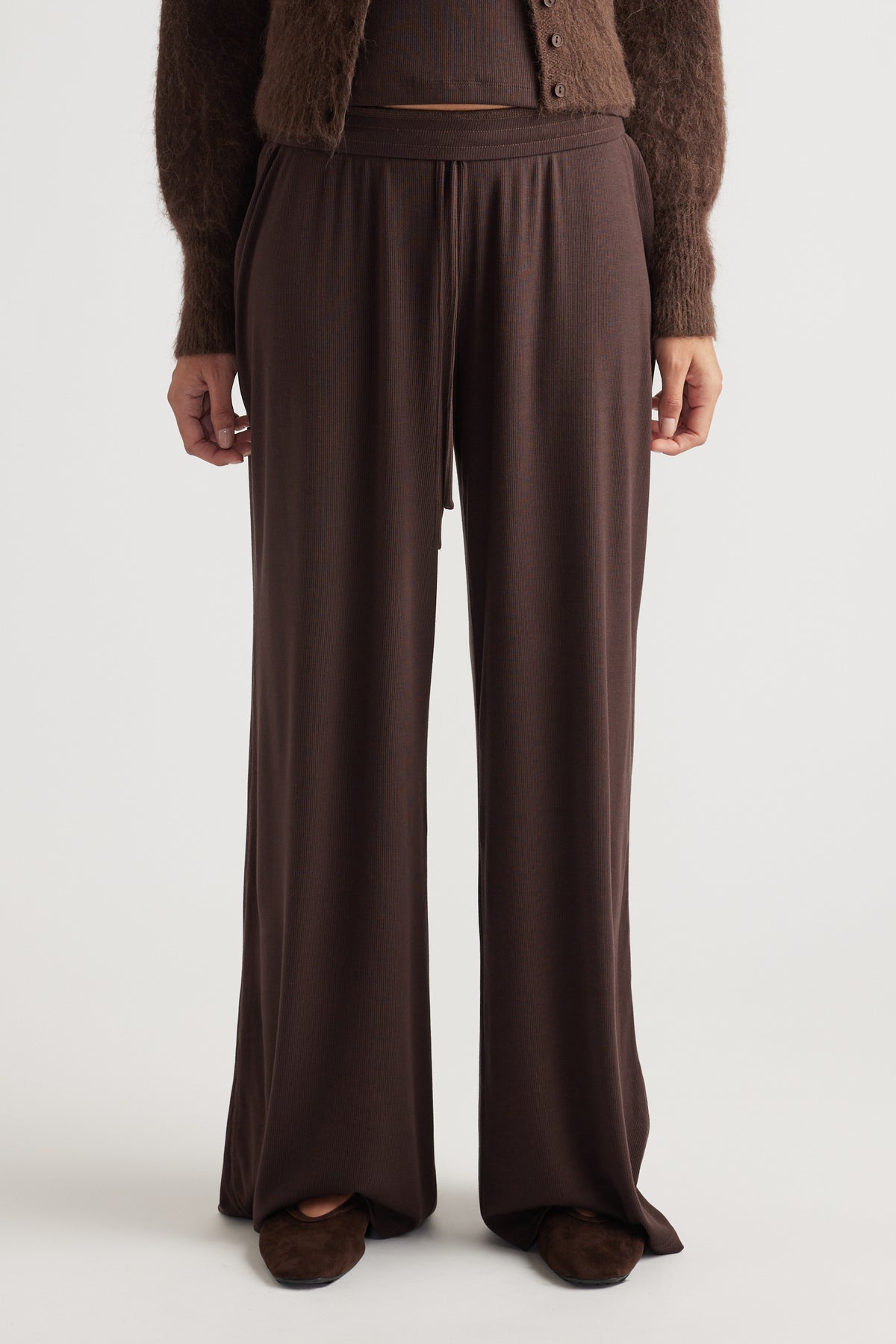 Soft ribbed wide-leg lounge pants in deep chocolate hue with relaxed fit and elastic waistband detail