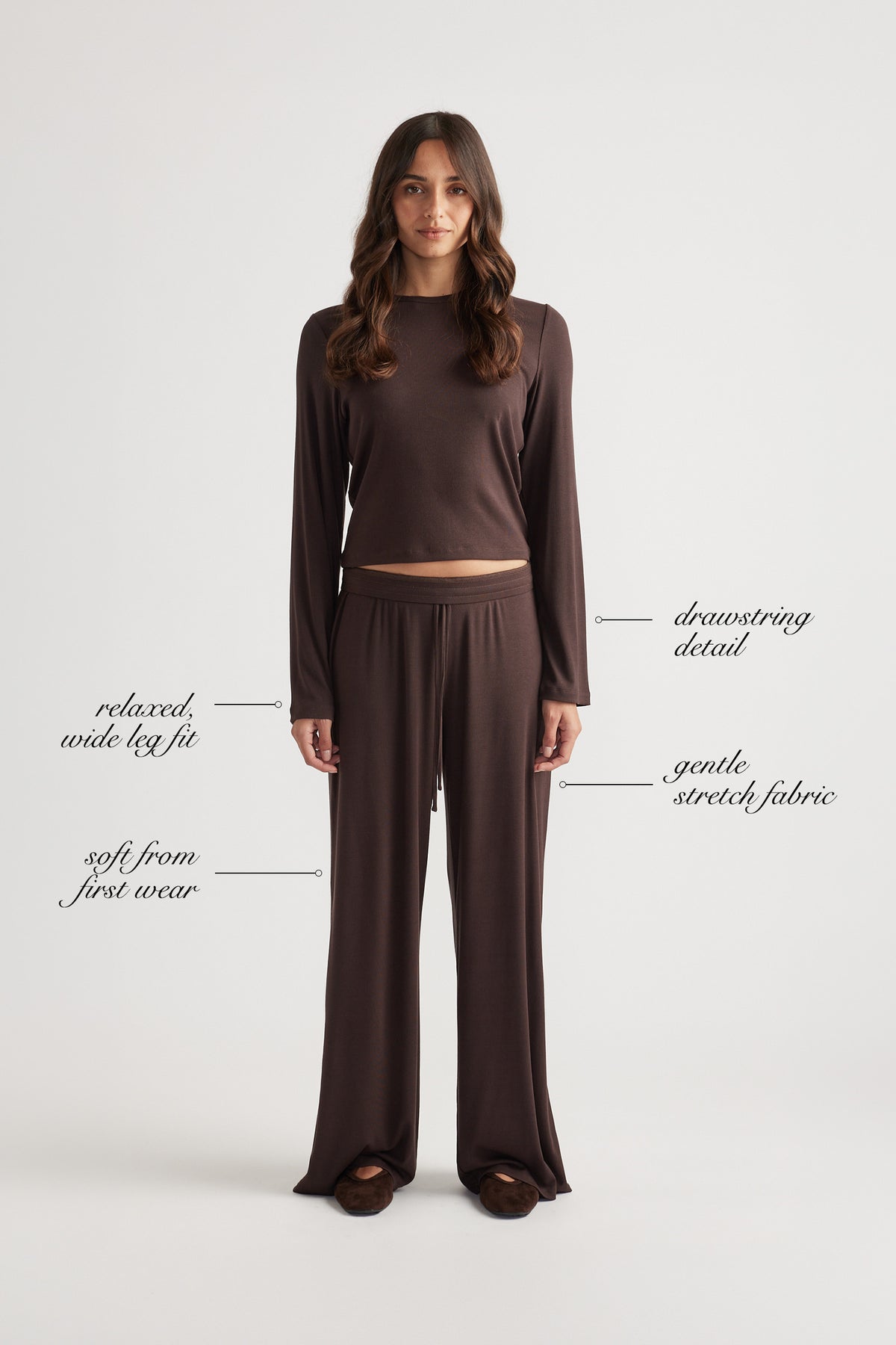 Woman in relaxed chocolate ribbed wide leg pants with drawstring waist and matching long sleeve top in soft stretch fabric