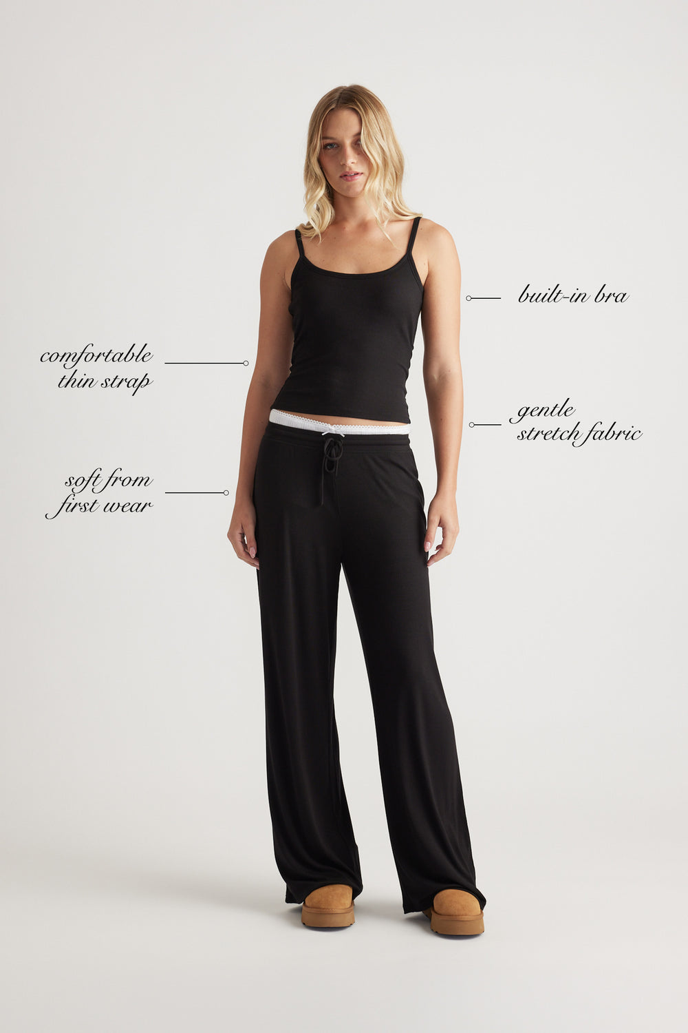 Woman wearing black ribbed cami top with built-in bra and relaxed black wide leg pants for effortless comfort