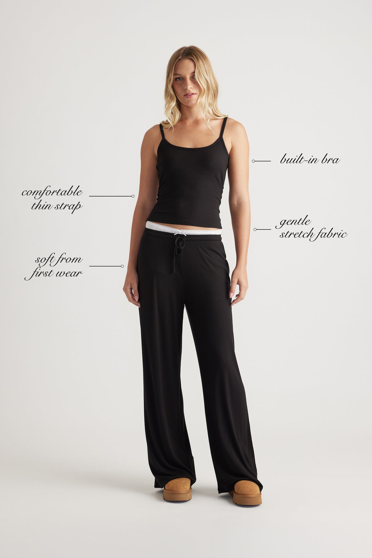 Woman wearing black ribbed cami top with built-in bra and relaxed black wide leg pants for effortless comfort