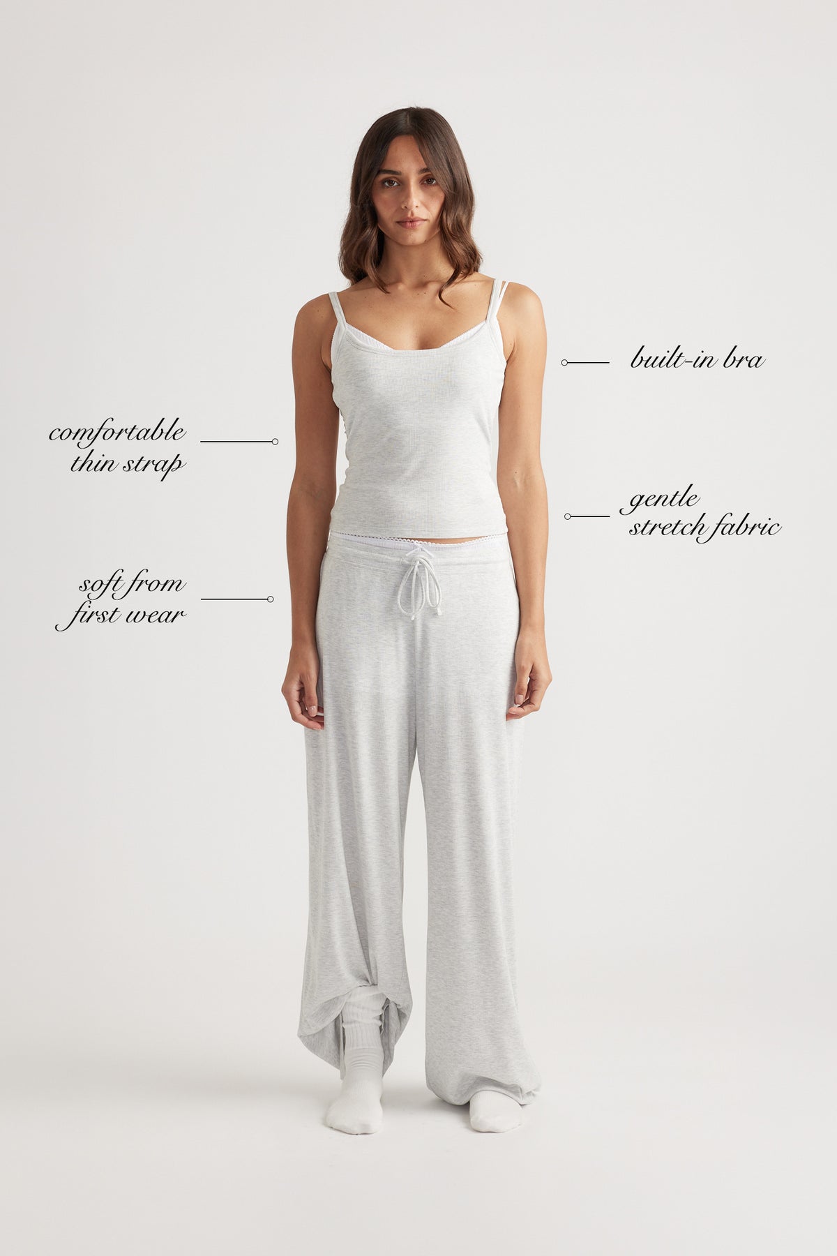 Woman wearing light grey ribbed cami with built-in bra and matching wide leg lounge pants with drawstring waist
