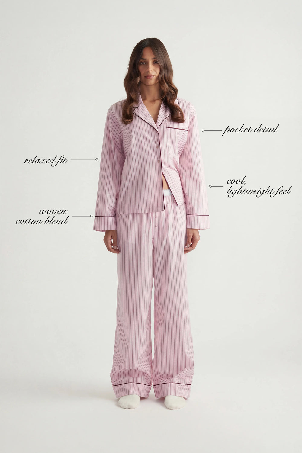Woman wearing lightweight pink striped woven long sleeve shirt and matching wide-leg pants with relaxed fit
