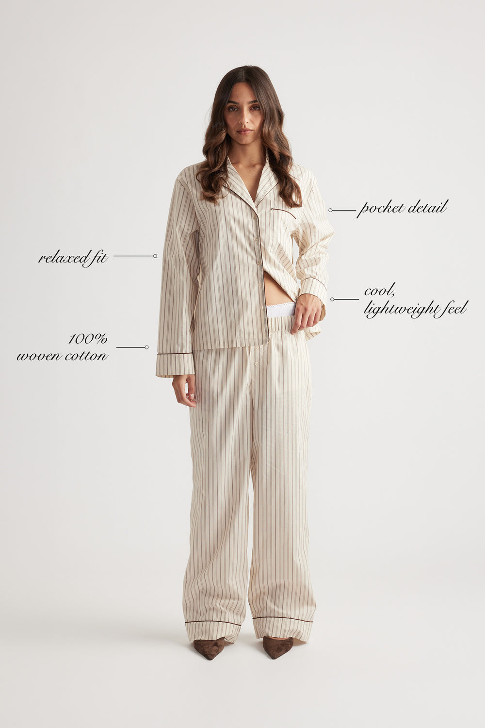 Woman wearing cream striped sleep shirt and matching wide-leg woven cotton pants with relaxed fit and pocket detail