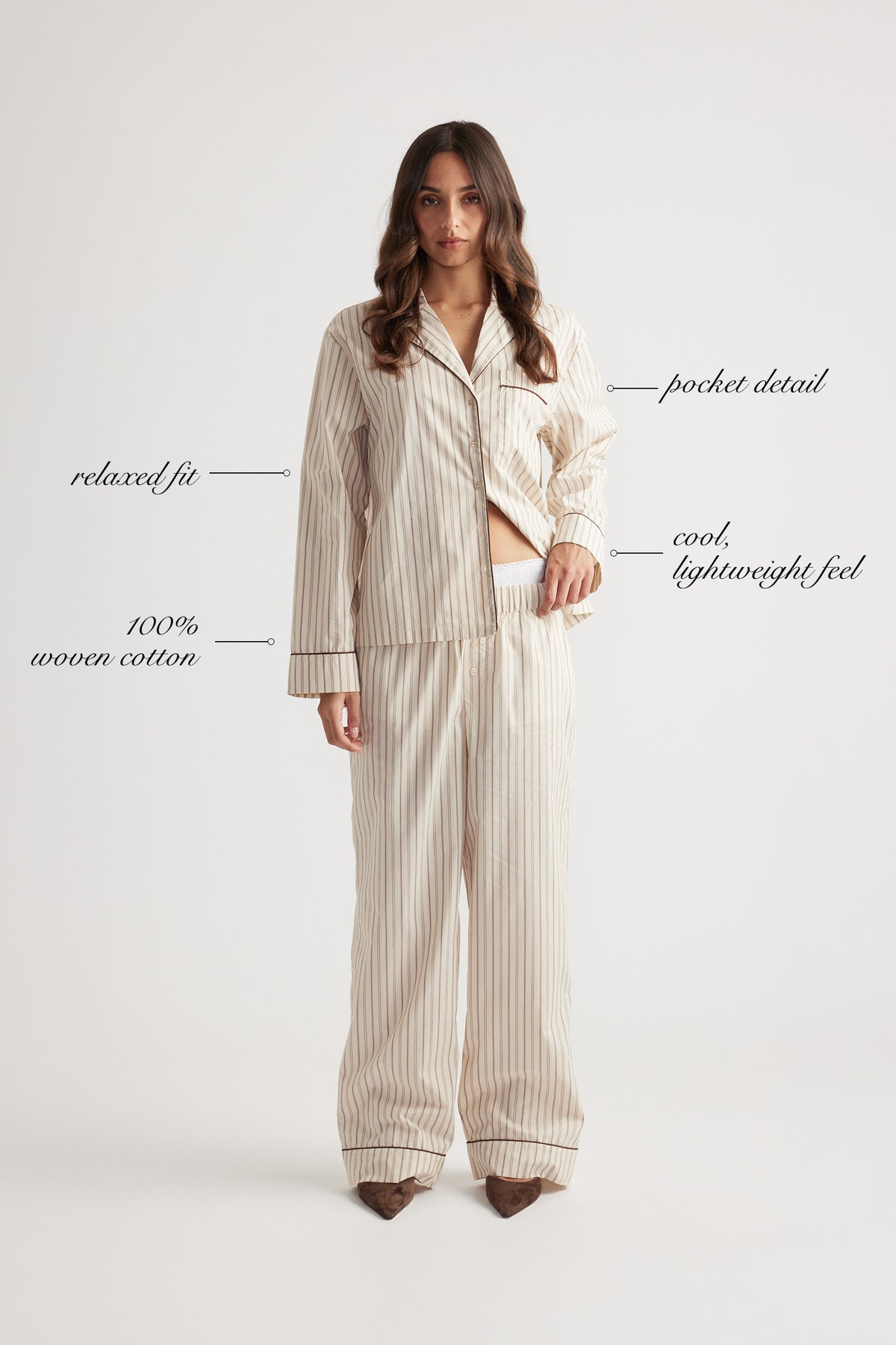 Woman wearing cream striped sleep shirt and matching wide-leg woven cotton pants with relaxed fit and pocket detail