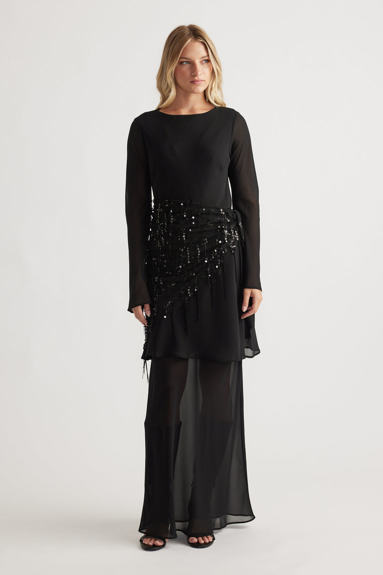 Chelsea Georgette Mini Dress in black featuring long sheer sleeves and sequin embellishments on a flowing layered skirt by DECJUBA