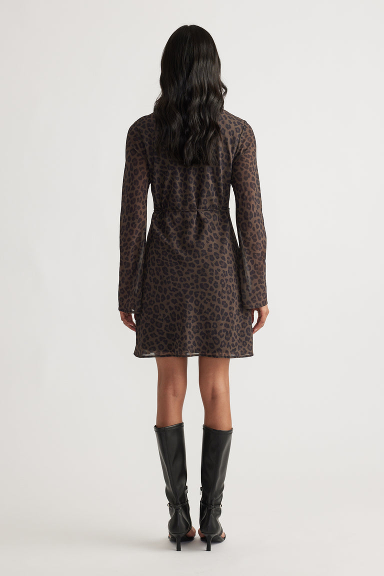 Chelsea Georgette Mini Dress in dark leopard print with long sleeves, styled with knee-high black boots by DECJUBA