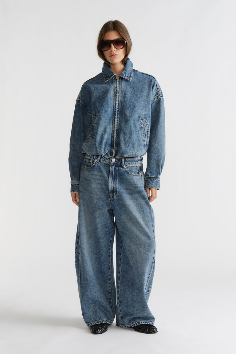 D-Luxe Barrel Jean in relaxed wide-leg fit with classic blue wash, styled with denim jacket and sunglasses by DECJUBA Australian brand