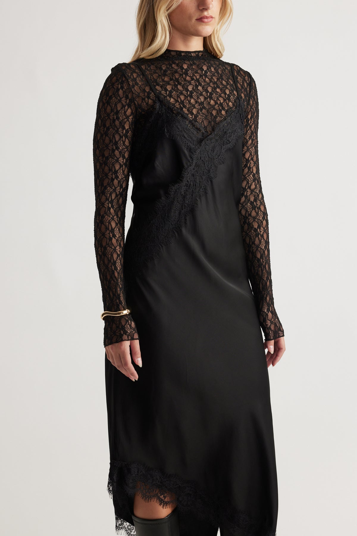 Woman wearing a black Karla Lace Midi Dress with lace long sleeves and delicate lace trim for a chic, elegant look