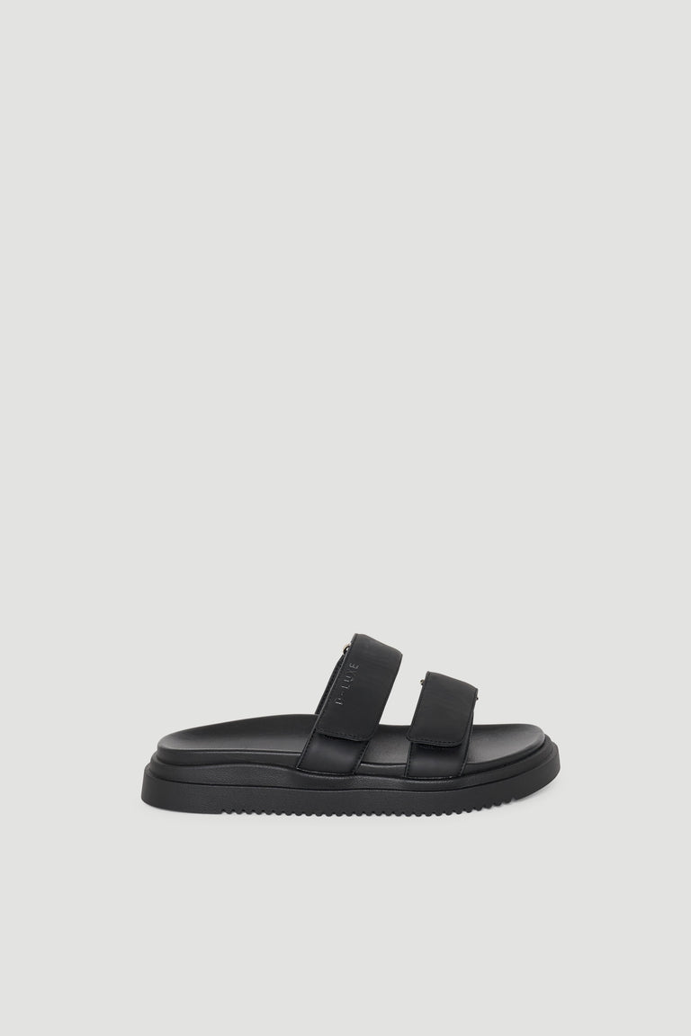 Black slip-on slide sandal with two wide adjustable straps and a cushioned sole for everyday comfort