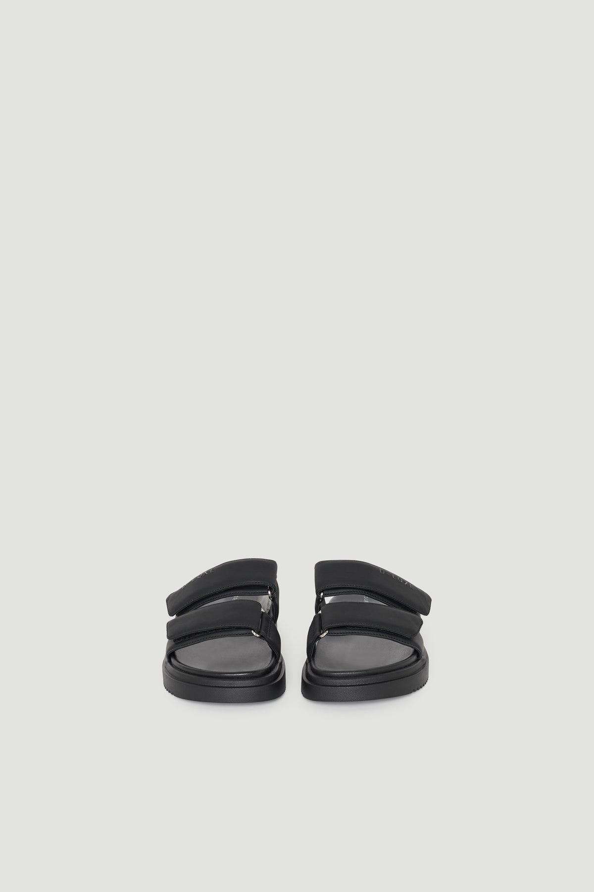 Pair of black slide sandals with dual padded straps and a cushioned sole for comfortable, everyday wear.
