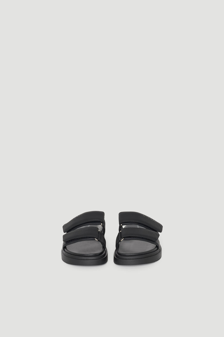 Pair of black slide sandals with dual padded straps and a cushioned sole for comfortable, everyday wear.