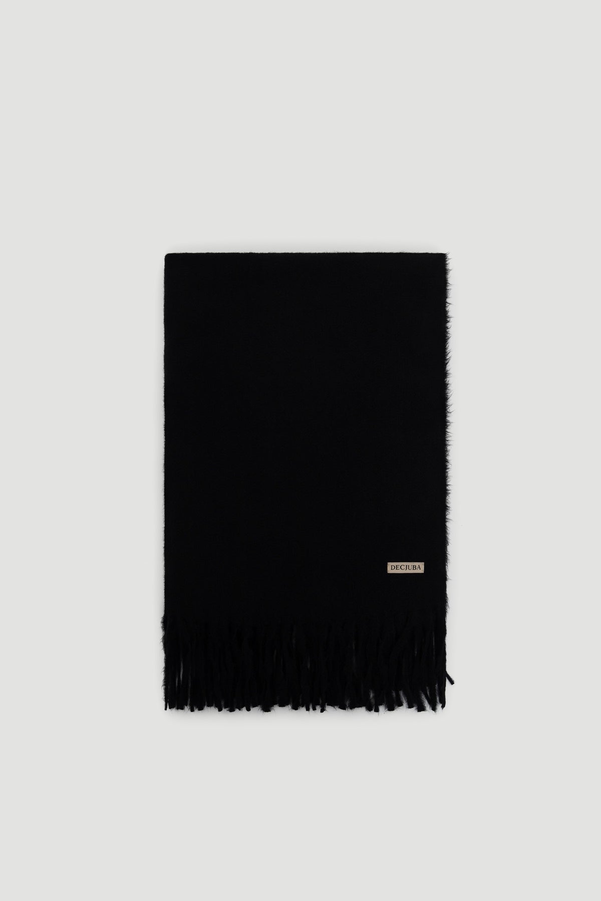 Black soft scarf with subtle fringe detailing and a small branded tag near the edge for a sleek finish