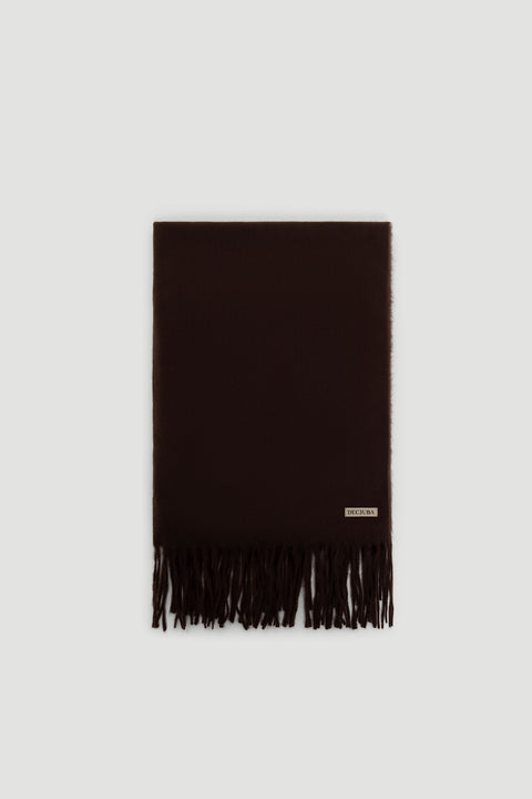 Dark chocolate solid scarf with soft texture and fringed ends, featuring a small branded label near the edge