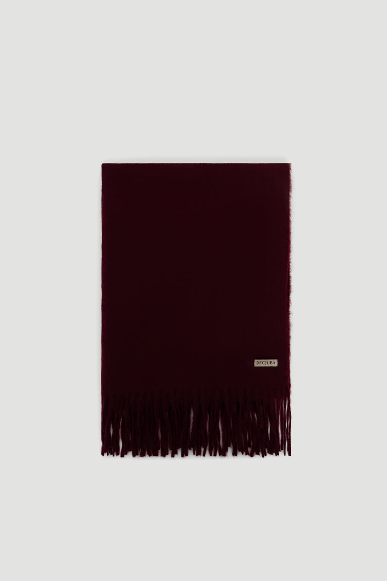 Soft deep plum scarf with delicate fringed edges and a small branded label for an elegant touch