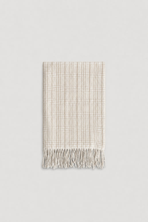 Light beige check patterned scarf with soft texture and delicate fringe edges for a cozy, stylish touch