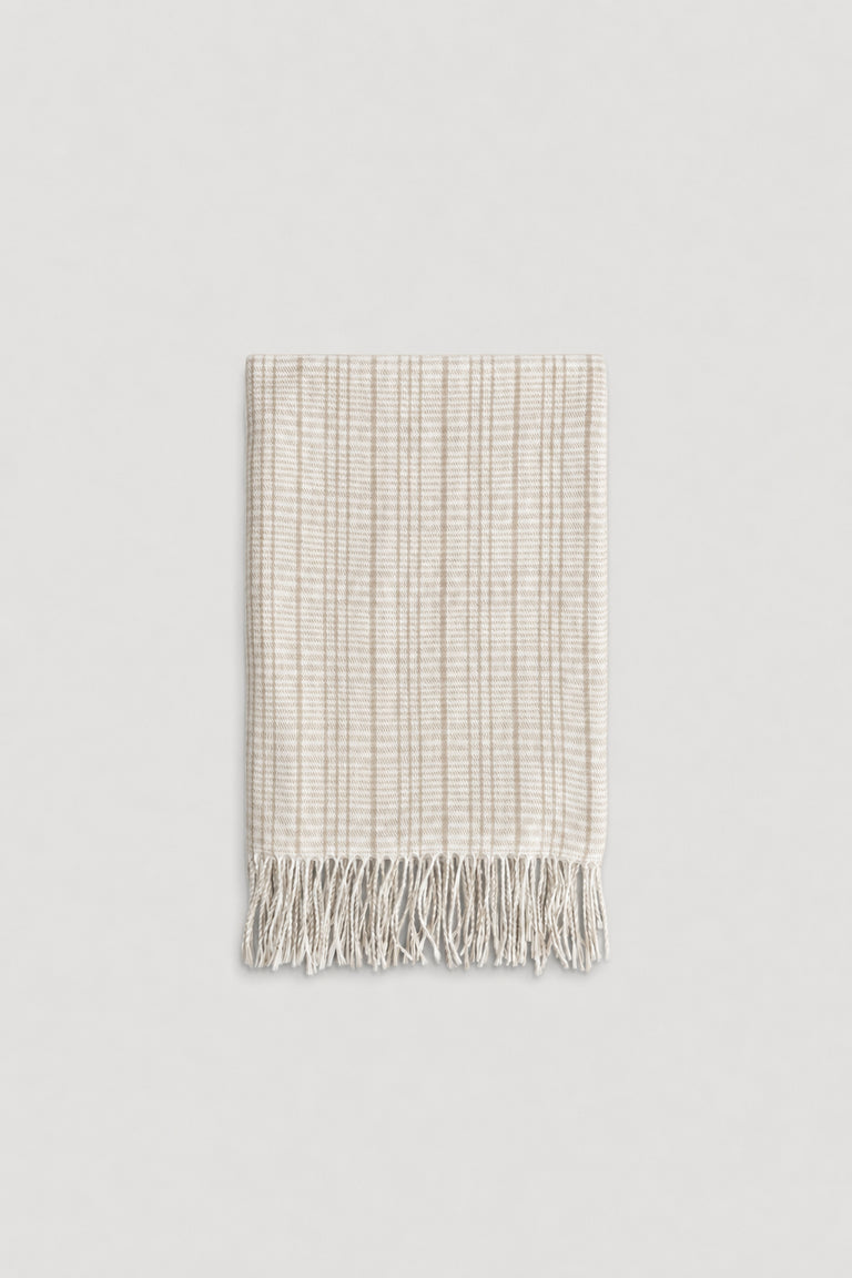 Light beige check patterned scarf with soft texture and delicate fringe edges for a cozy, stylish touch