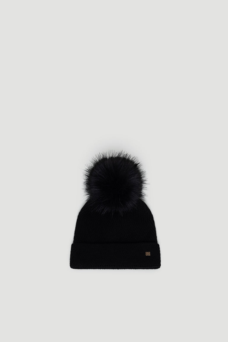 Black Demi Pom Beanie with a fluffy pom-pom and cuffed edge, designed for cozy, stylish winter wear by DECJUBA.