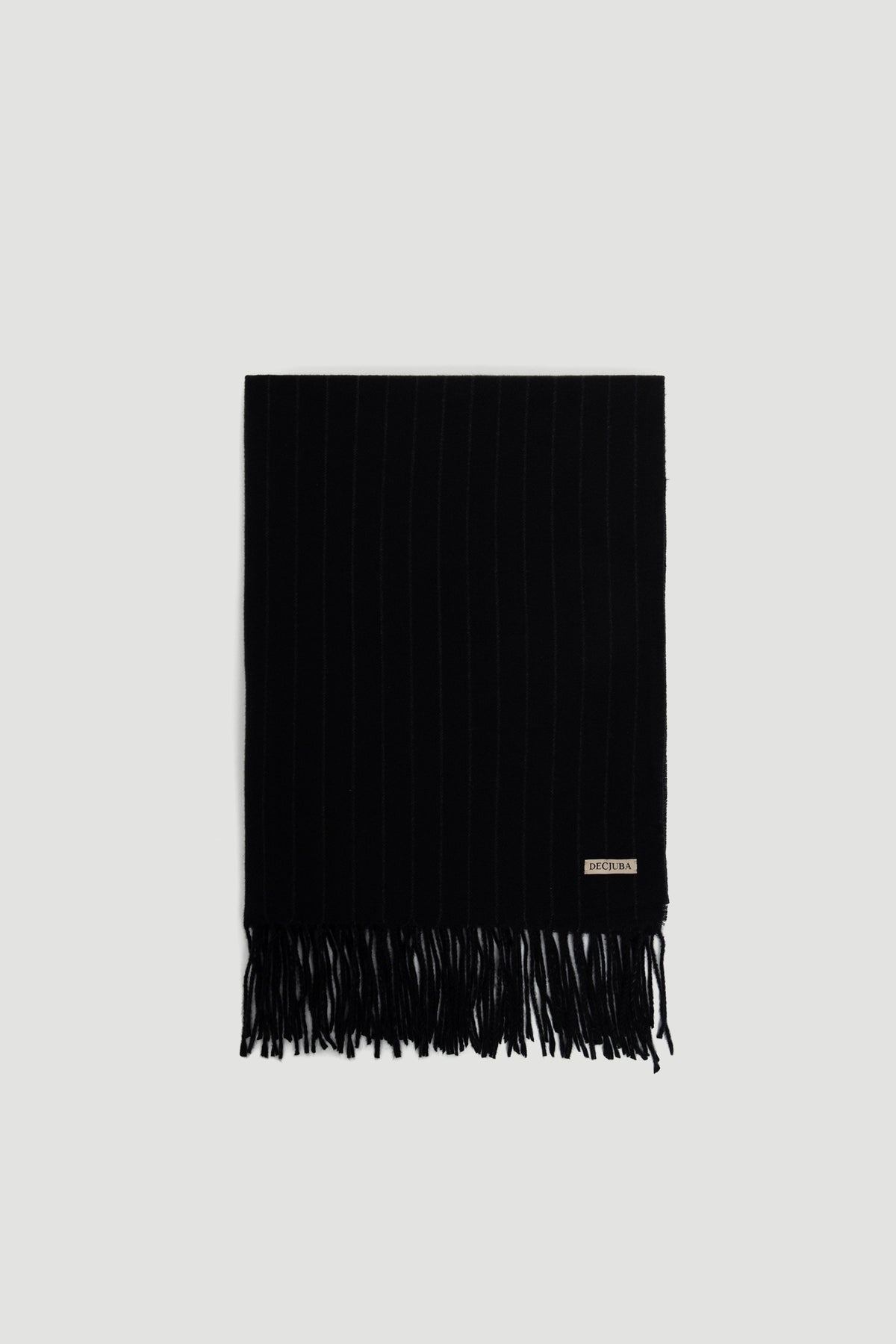 Gia Stripe Scarf in deep charcoal with subtle pinstripes and fringe trim, featuring a small DECJUBA logo patch.