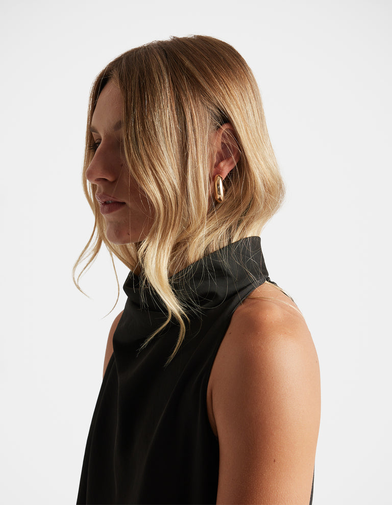 Side profile of woman wearing Mila 3 Pack Earrings in polished gold hoops by DECJUBA Australian fashion brand