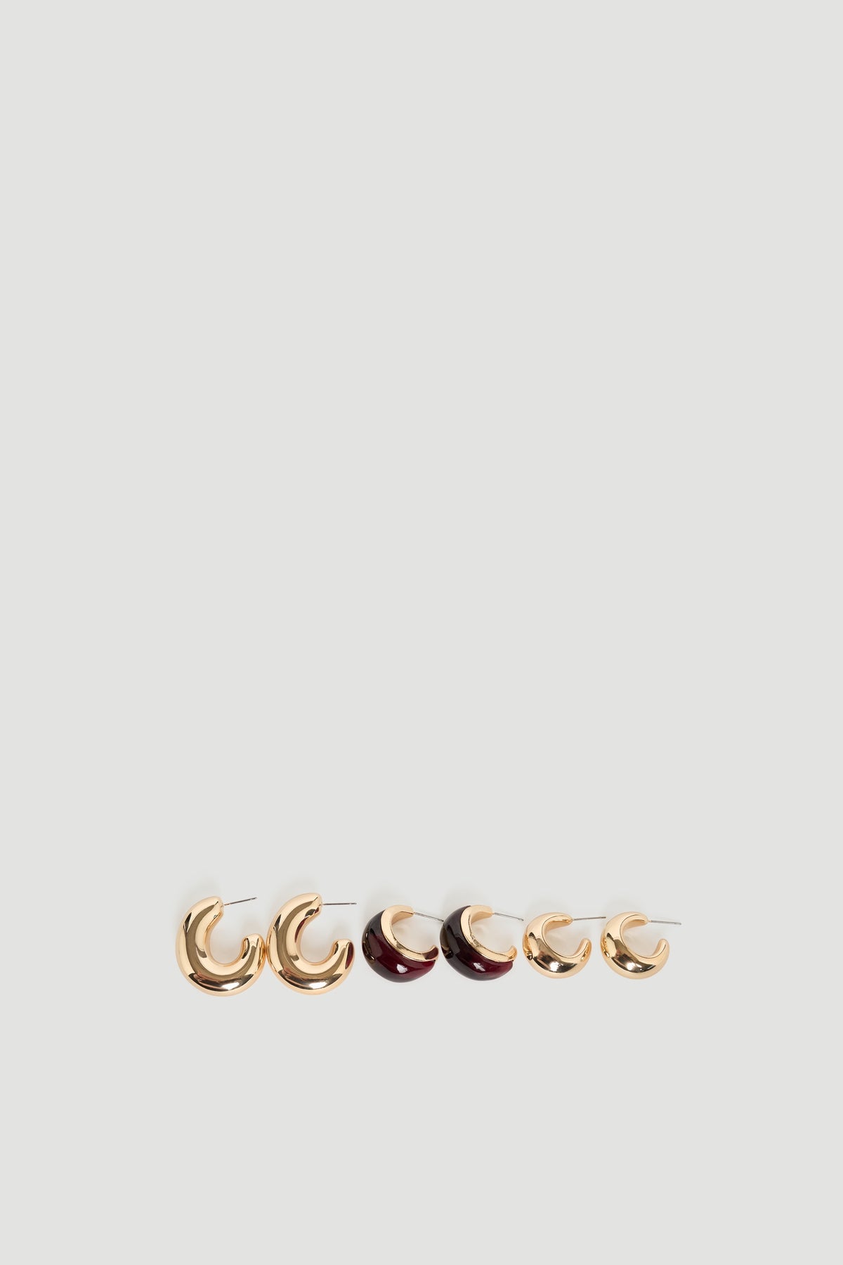 Mila 3 Pack Earrings showcasing polished gold and deep red hoop styles by DECJUBA Australian fashion brand