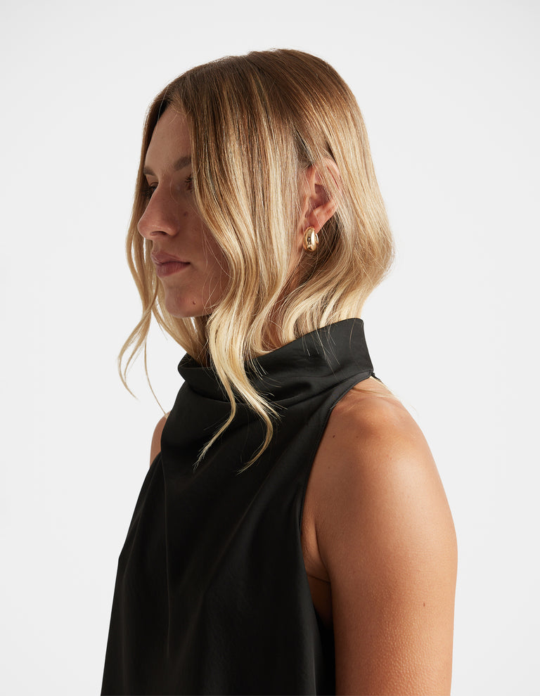 Profile view of woman wearing polished gold hoop from Mila 3 Pack Earrings by DECJUBA Australian fashion brand