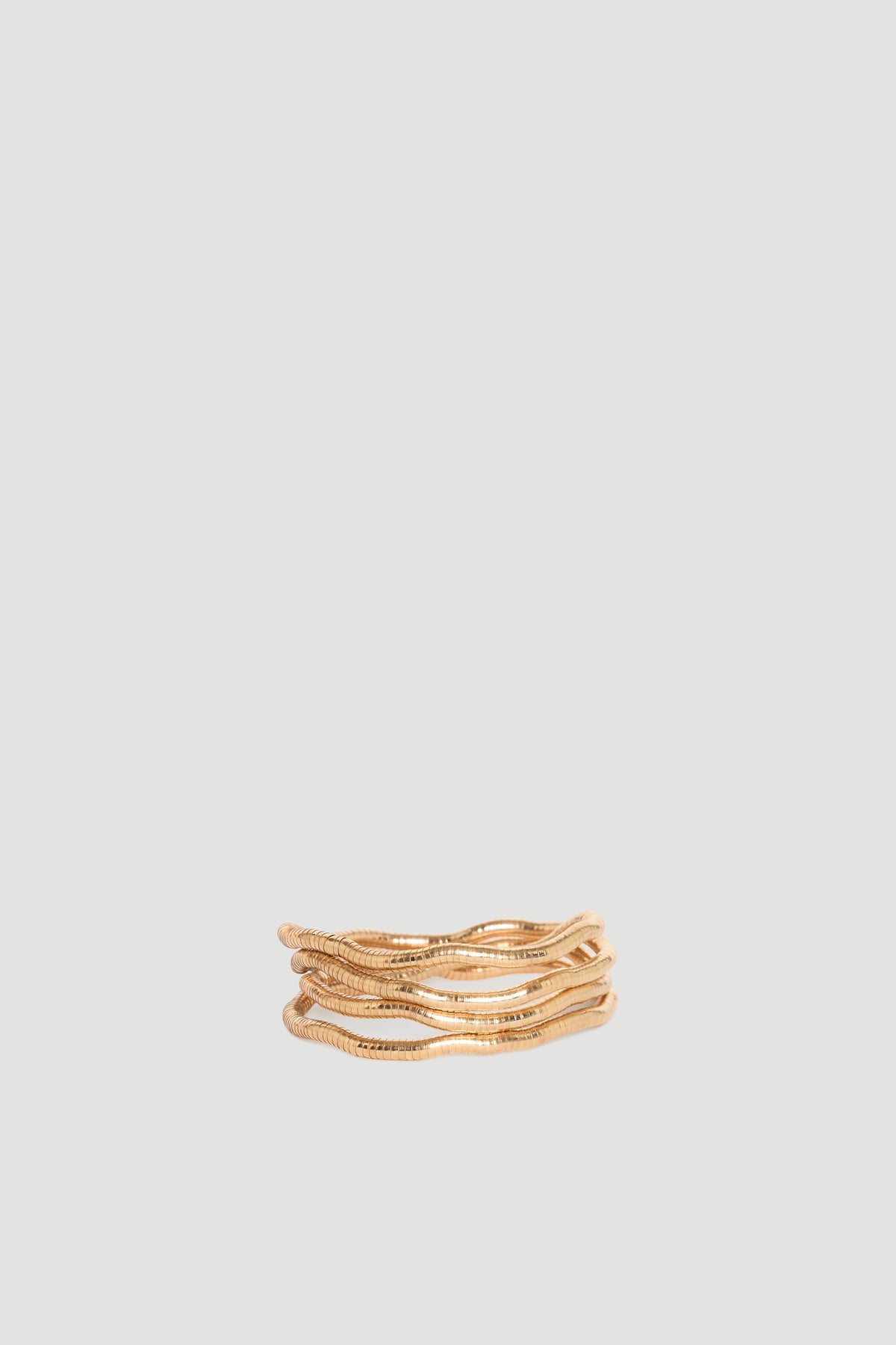 Maya Wrap Bracelet in polished gold-tone with layered wavy design, effortlessly stylish by DECJUBA Australian fashion brand