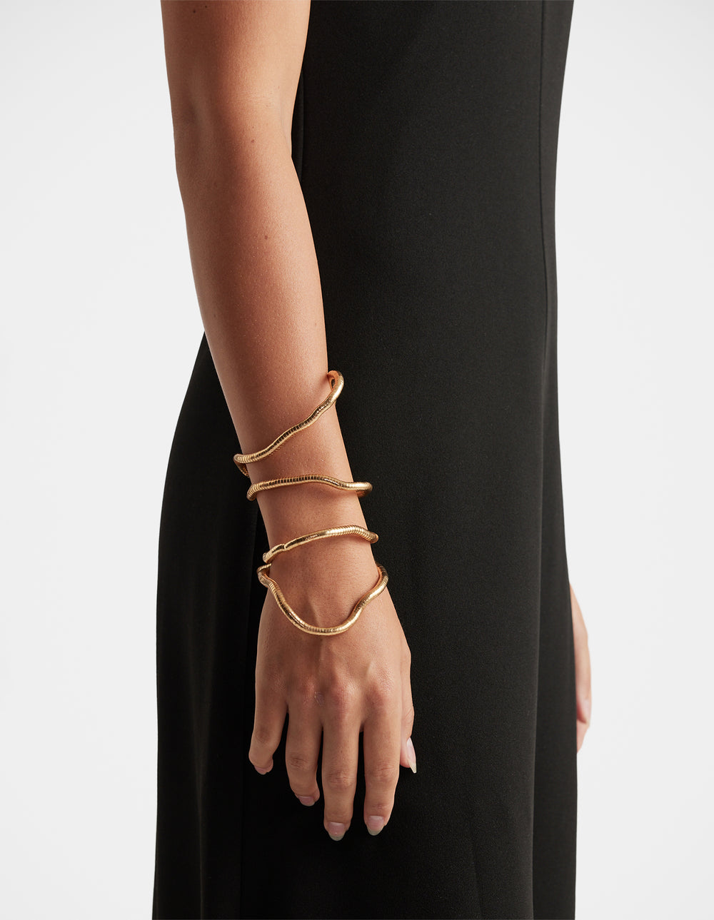 Maya Wrap Bracelet in polished gold-tone featuring fluid layered design, effortlessly elegant by DECJUBA Australian fashion brand
