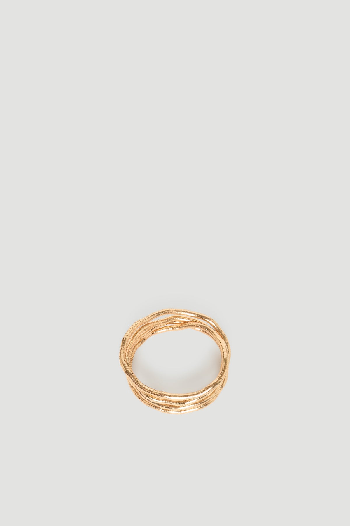 Maya Wrap Bracelet in polished gold-tone featuring intertwined delicate layers, effortlessly chic by DECJUBA Australian fashion brand