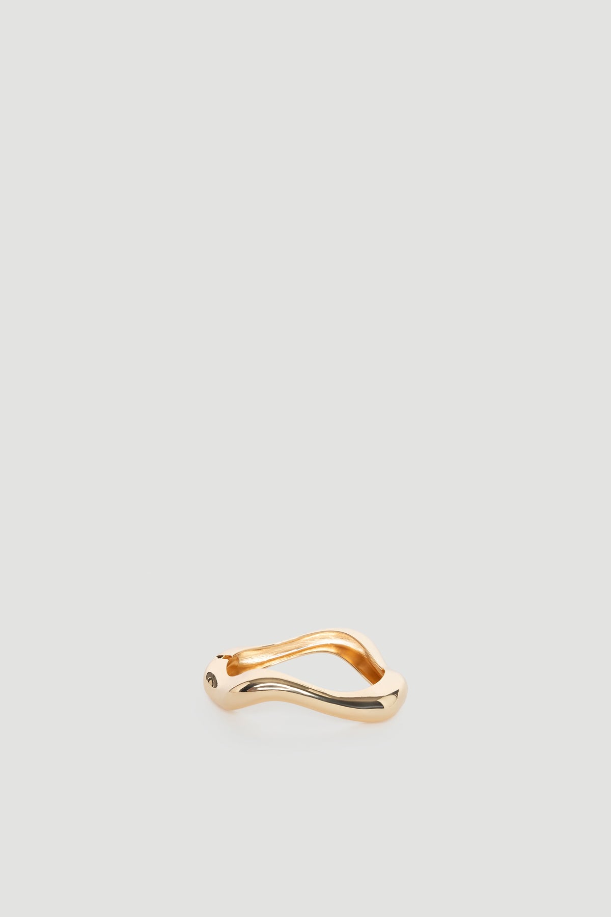 Ella Wavy Bracelet in polished gold tone with smooth, flowing curves creating a bold and elegant statement piece.