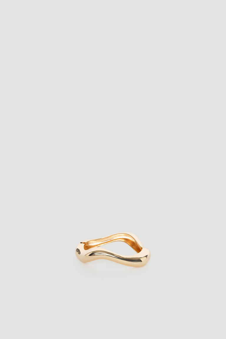 Ella Wavy Bracelet in polished gold tone with smooth, flowing curves creating a bold and elegant statement piece.